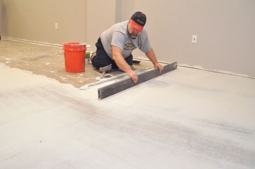 Flattening the floor in preparation for tile