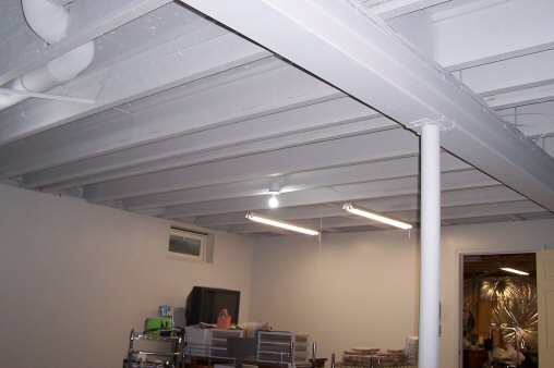 gray spray painted basement ceiling