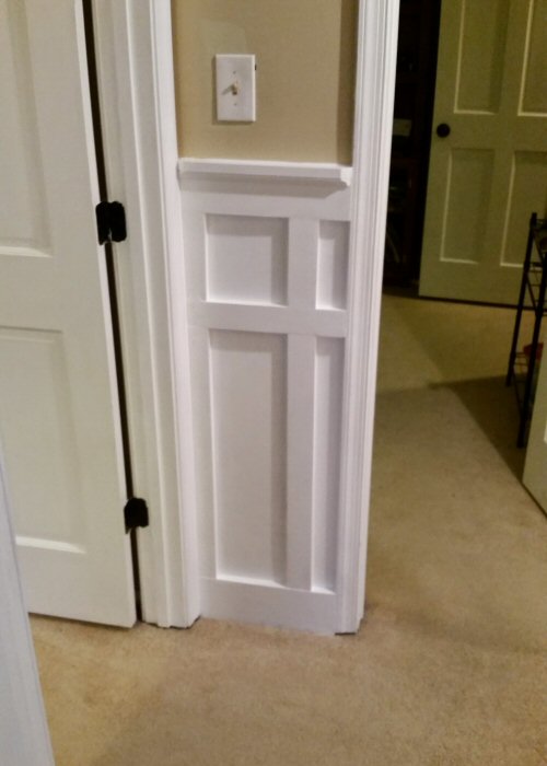 Short Section of White Board and Batten between Two Doorways